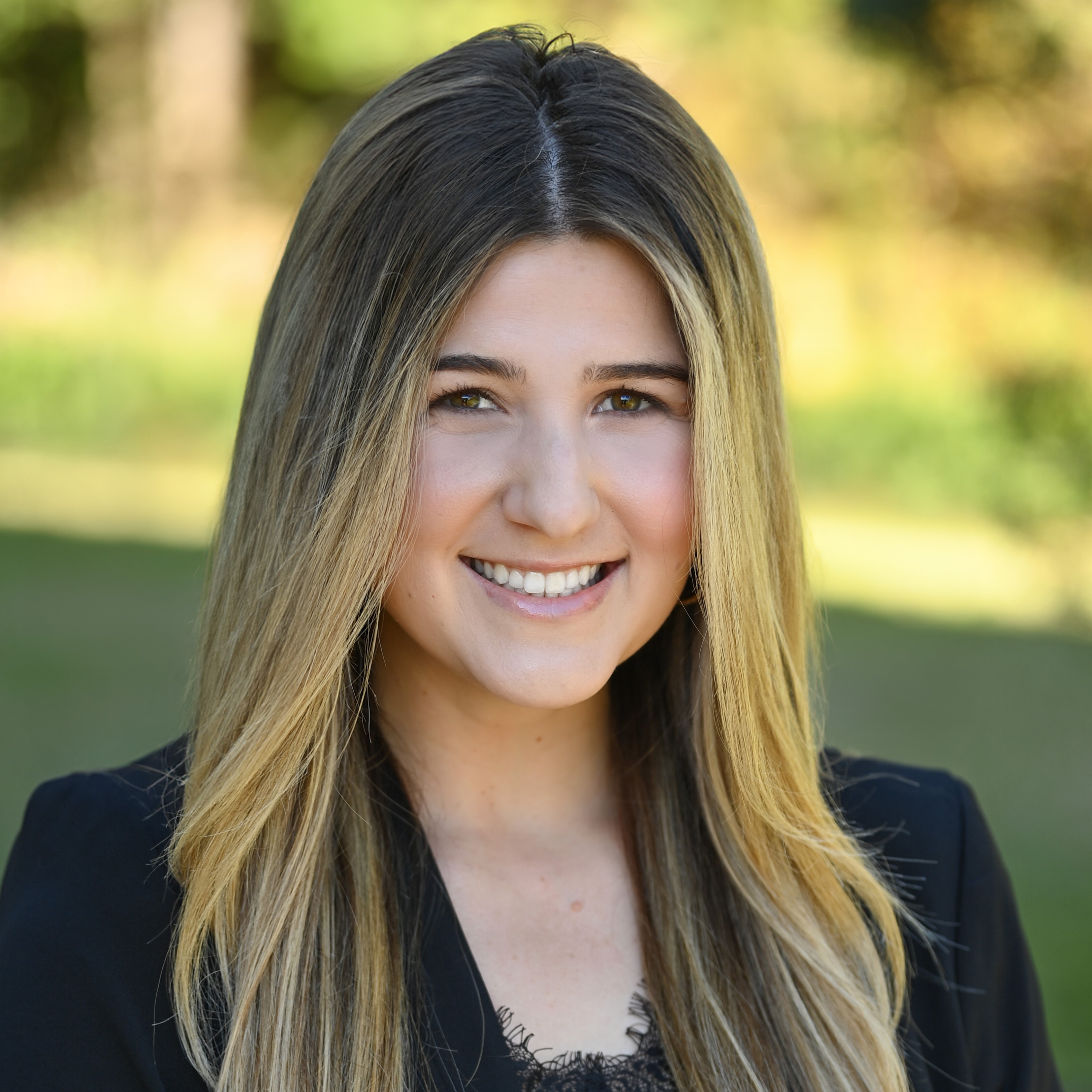 A woman smiling for a professional headshot.