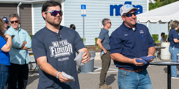 Two Guys Playing Cornhole