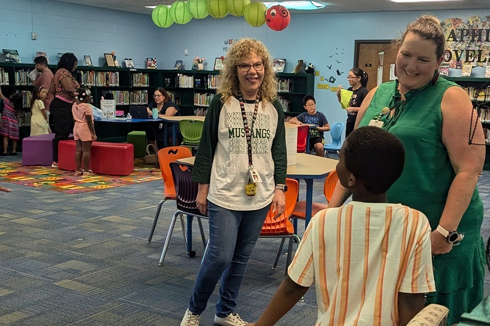 Ayers and teacher in classroom with students