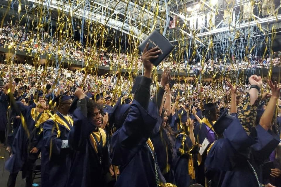 University High graduates celebrating with confetti