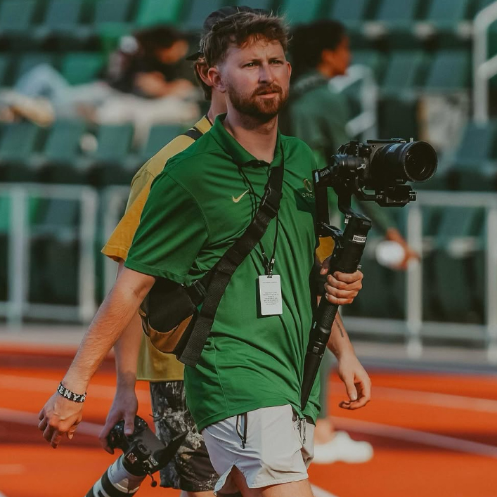 Anderson Bobo holding camera at track championship