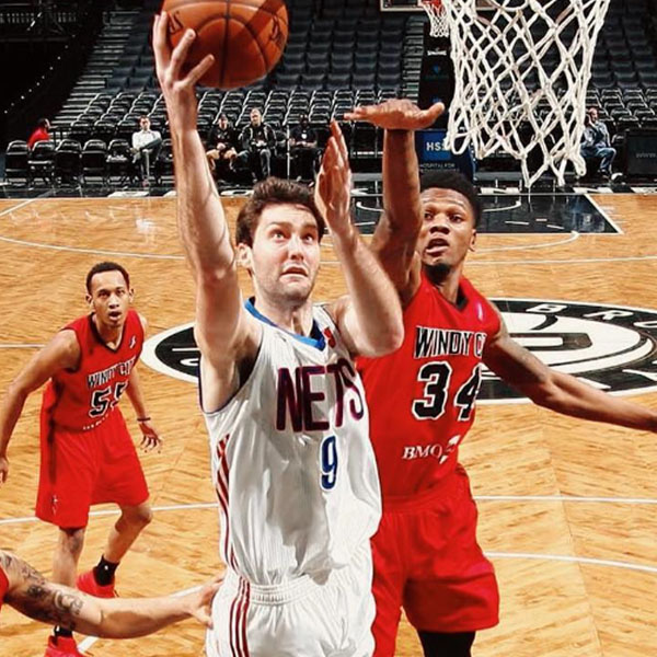 beau doing a lay up while a defender tries to block him