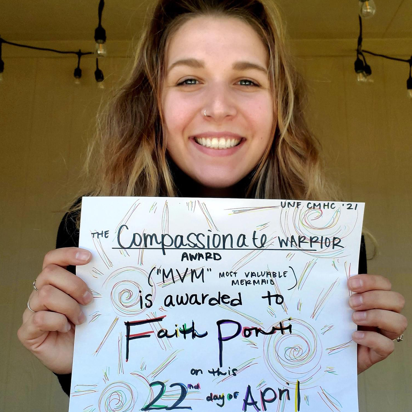 faith ponti holding up her certificate