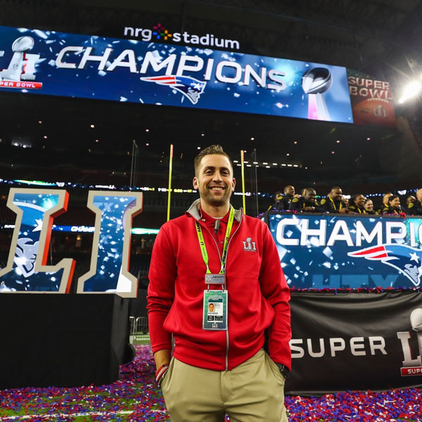 jason in the houston stadium with champion banner behind him
