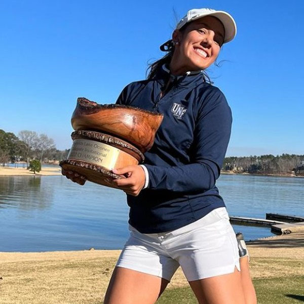 mindy holding a championship trophy