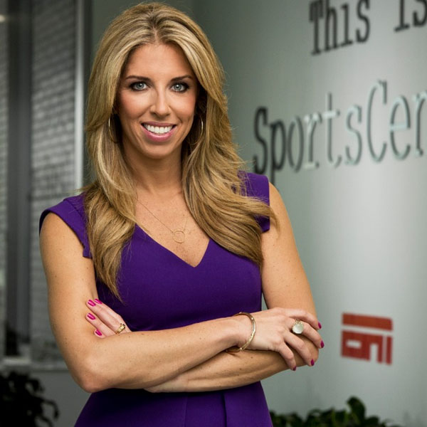 sara standing next to a sports center wall
