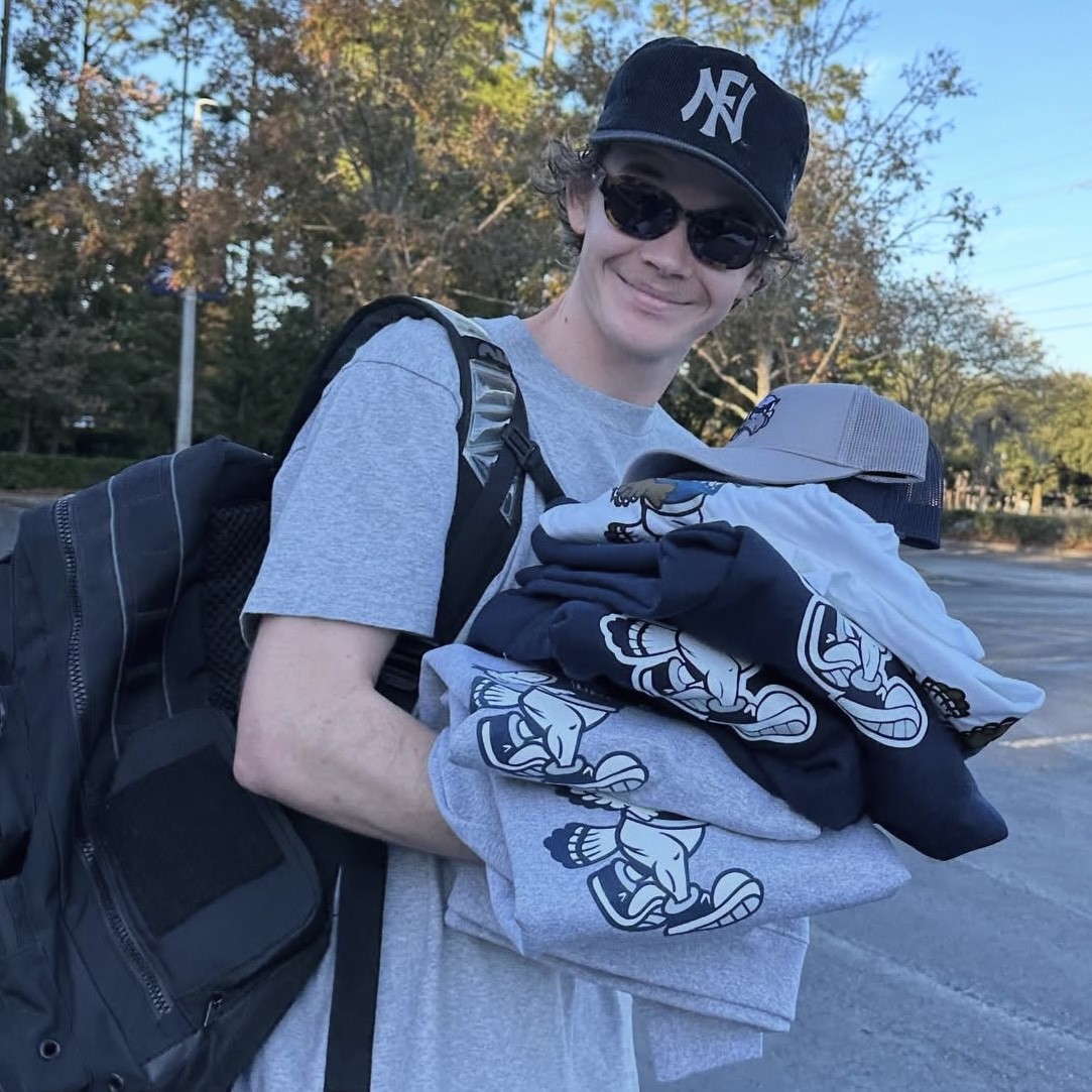 Will Pease holding shirts