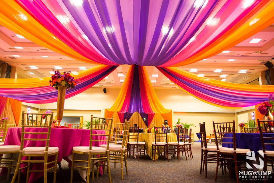 University Center room decorated with orange, purple, and pink drapes