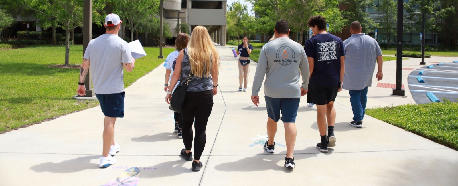 Tour guide guests being led by a UNF student tour guide.