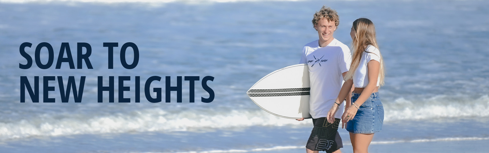 Sstudents walking along the beach with a surf board, text of soar to new heights