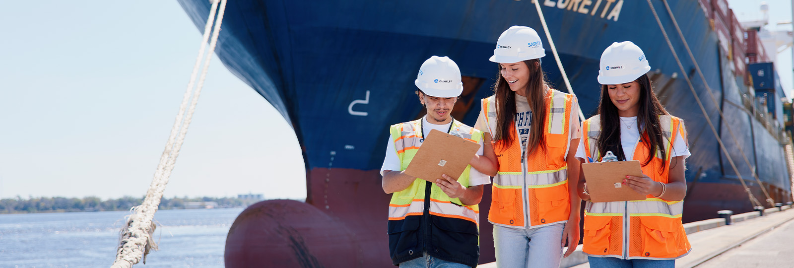 Students working at the shipyard while wearing high visibility jackets